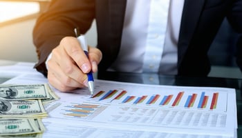 A business owner reviewing cash flow statements and loan options.