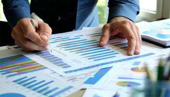 Business owner reviewing financial documents for an acquisition.