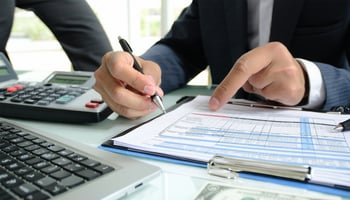 Business owner reviewing refinancing options to reduce debt costs.