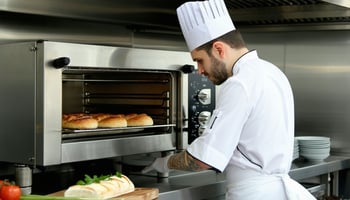 Chef using a leased commercial oven in a restaurant kitchen