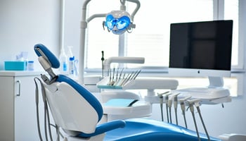  Dentist working in a modern operatory with a financed dental chair and delivery system