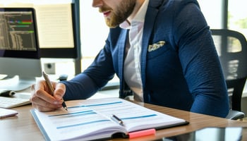 Entrepreneur reading a Franchise Disclosure Document at a desk.