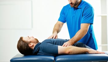 Physical therapist treating a patient on a financed treatment table