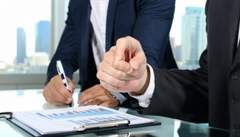 Small business owner reviewing pros and cons of equipment lease contract