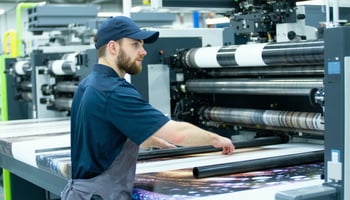 Technician operating a leased commercial digital printing press