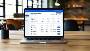 The image depicts a modern digital workspace, featuring a sleek laptop open to a vibrant, user-friendly online business lending platform interface.