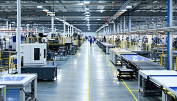 A modern manufacturing facility with a spacious production floor, high-tech machinery, and assembly lines, highlighting a clean and efficient workspace.