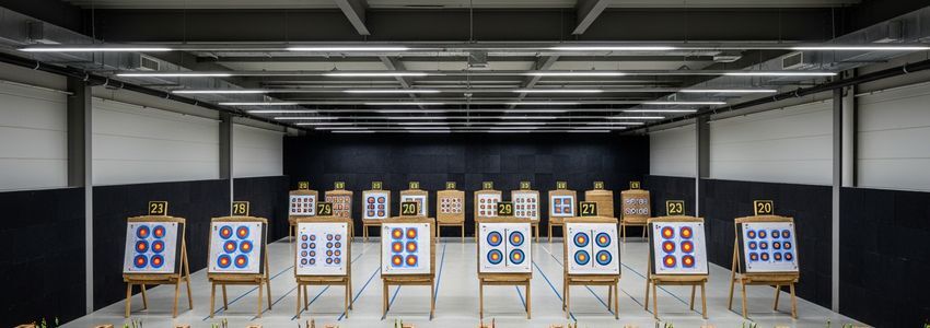 Professional indoor archery range with shooting lanes and targets