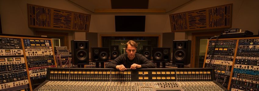 Professional audio equipment including PA speakers and mixing console in a commercial showroom