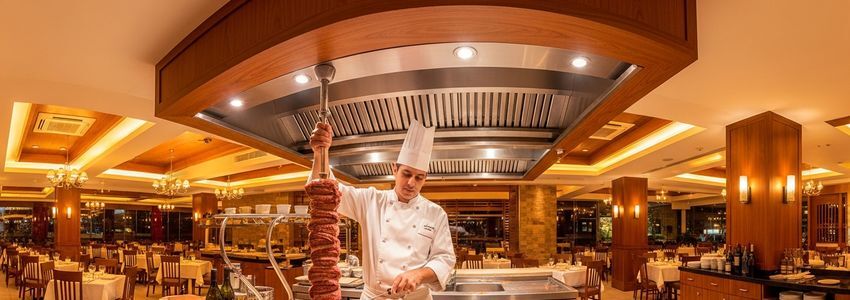 Brazilian churrascaria chef with skewer of meats in an upscale restaurant