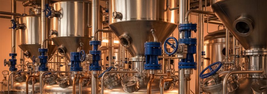 Modern pharmaceutical manufacturing facility with stainless steel reactors and processing equipment
