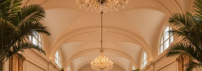 The image depicts a modern hotel lobby, featuring sleek, contemporary furnishings and a warm, inviting atmosphere. 