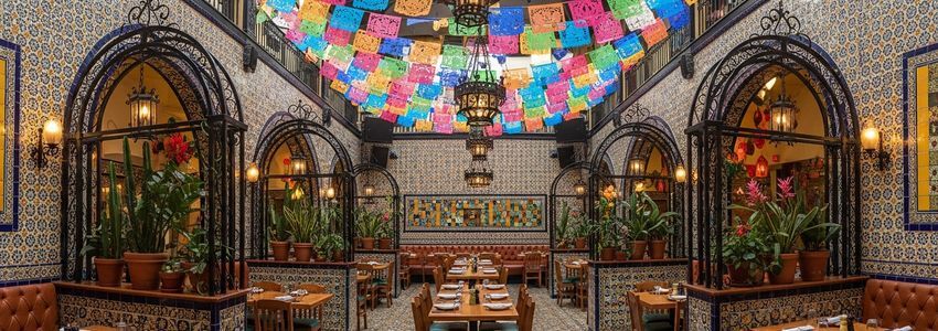 Colorful Mexican restaurant interior with traditional Talavera tiles and papel picado ready for business growth financing