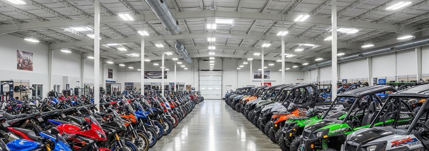 Professional motorsports dealership showroom with motorcycles and ATVs on display