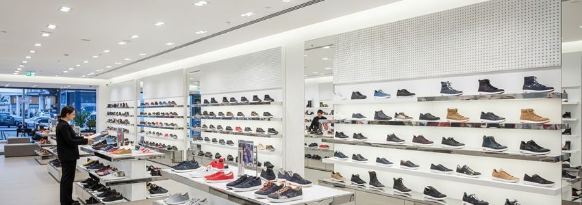 Shoe store interior with organized footwear displays and retail environment