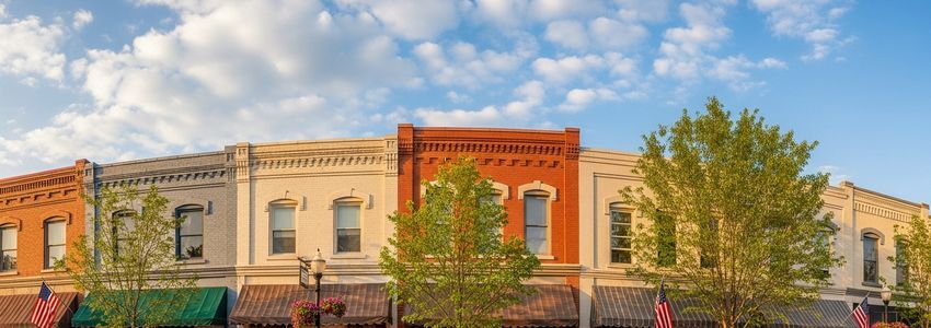 Small business district street in Little Rock Arkansas with brick storefronts and American flags representing local entrepreneurship and small business loans