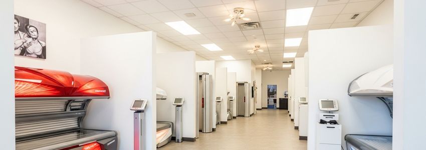 Professional tanning salon interior with multiple commercial tanning beds in private cubicles