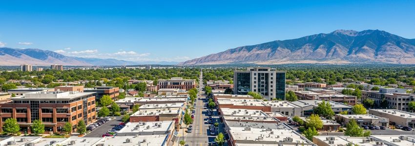 Small business district in West Valley City, Utah with Wasatch mountains in background