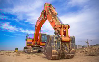 Tractor on a construction site being used to move soil and materials during a building project
