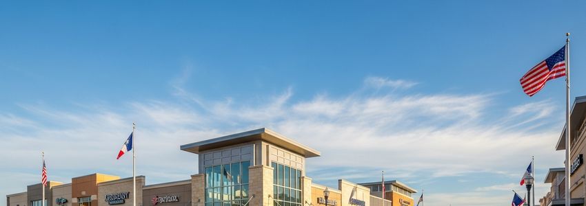 Small business owners discussing financing options in a modern Frisco, Texas office setting