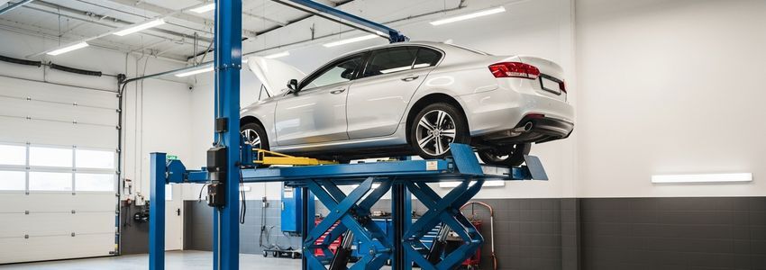 Professional automotive equipment inside a modern auto repair shop featuring a hydraulic lift and organized tools - ideal for equipment financing