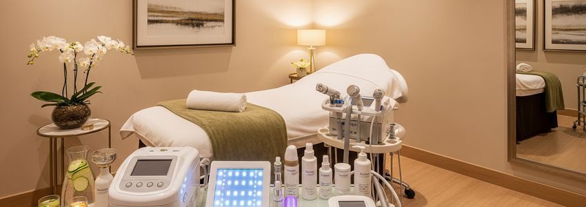 Beauty spa treatment room with professional aesthetic equipment and financing options