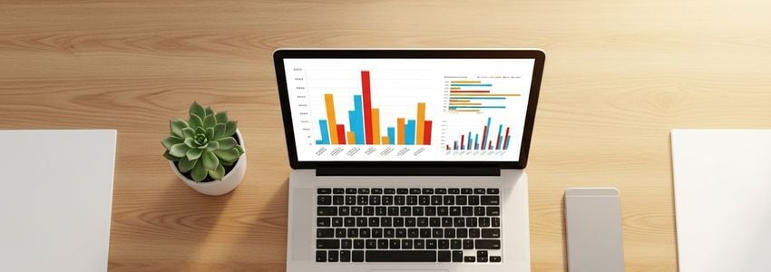 Professional office desk with laptop displaying financial charts relevant to business lines of credit and financing