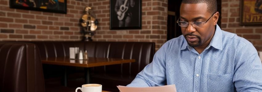 Cajun restaurant owner reviewing business loan documents