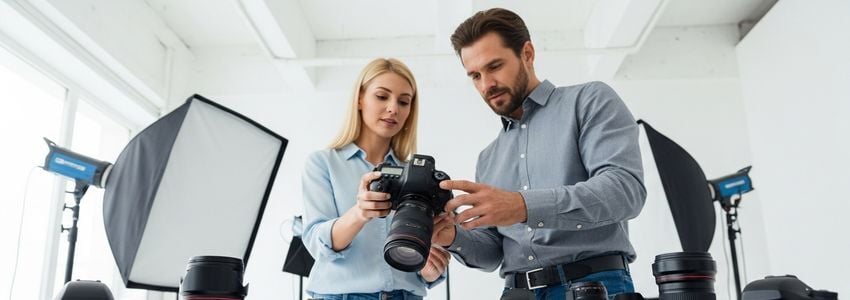 Business owner reviewing professional camera equipment options for equipment financing