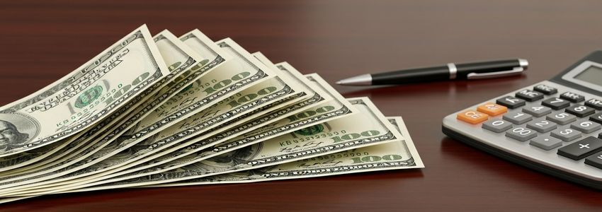 Small business owner reviewing cash flow statements at their desk