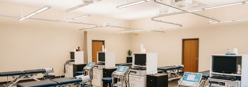 Chiropractor reviewing equipment financing options in a modern practice