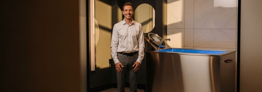 Business owner reviewing cold plunge financing options in a modern wellness studio