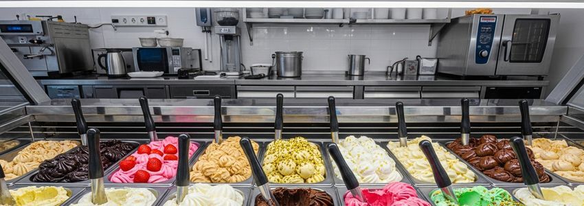 Ice cream display case in a Cold Stone Creamery franchise location showing premium flavors