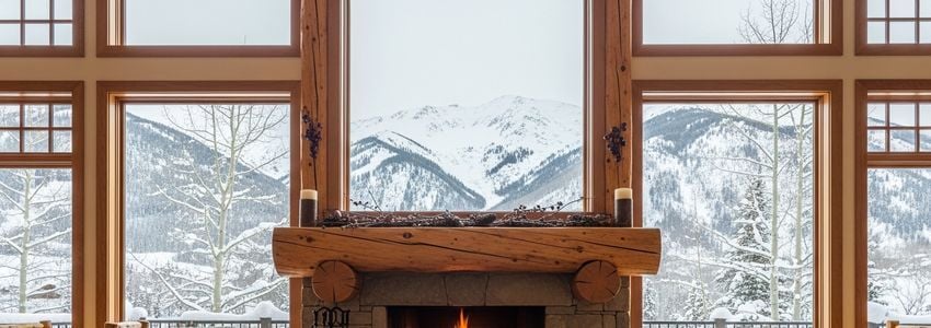 Colorado mountain ski lodge interior with fireplace and mountain views - perfect setting for ski resort business financing discussions