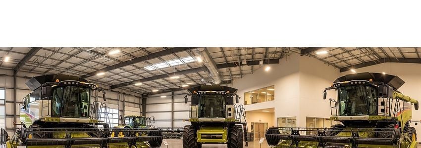 Agricultural business owner reviewing combine harvester financing documents in a farm office