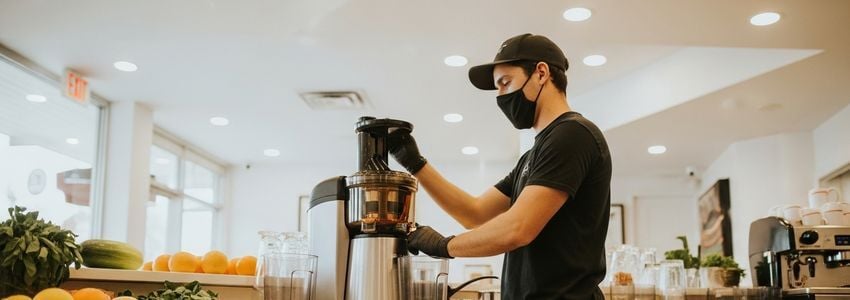 Commercial juicer equipment financing for food service businesses - juice bar owner with cold-press juicer