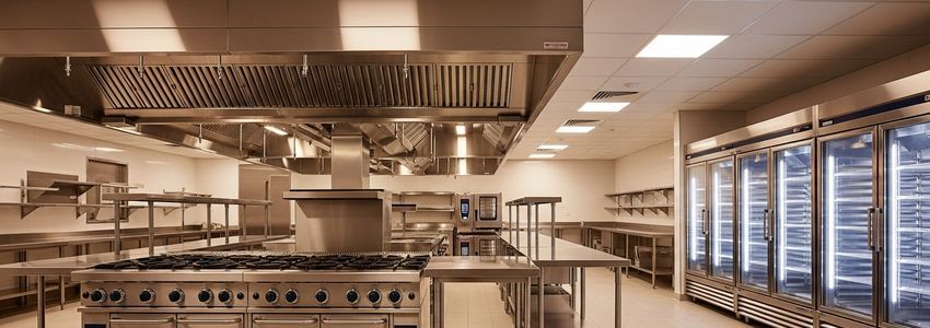 Fully equipped commercial kitchen with stainless steel appliances ready for first service after build-out financing