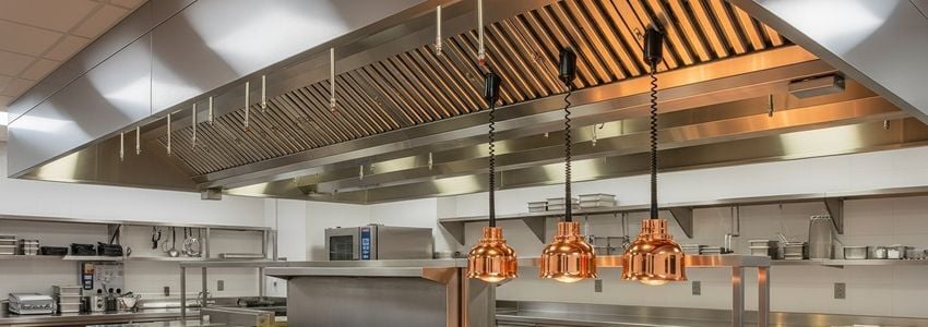 Restaurant owner reviewing commercial range hood financing options in a professional kitchen office