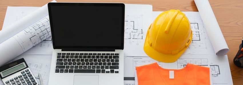 Construction business owner reviewing loan documents and financial plans for equipment and project funding