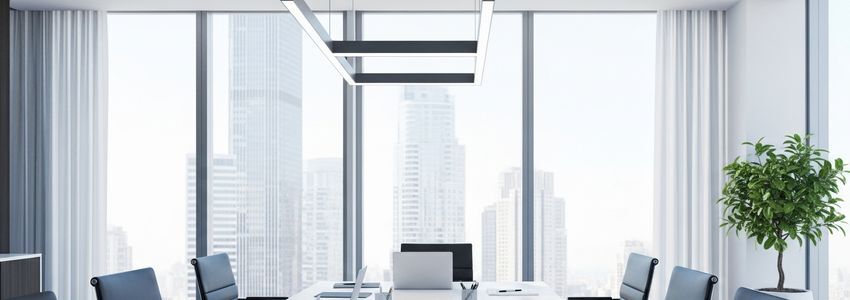 Business professional reviewing financing strategy options at a modern office conference table