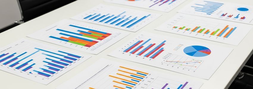 Business professionals reviewing credit line data and industry financing charts