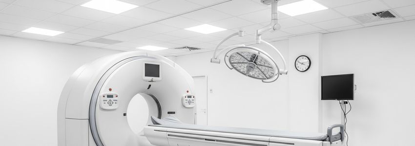 Hospital administrator reviewing CT scanner financing documents at a modern medical office