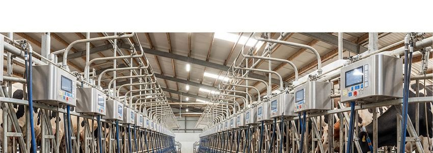 Dairy farmer reviewing equipment financing documents at modern farm office