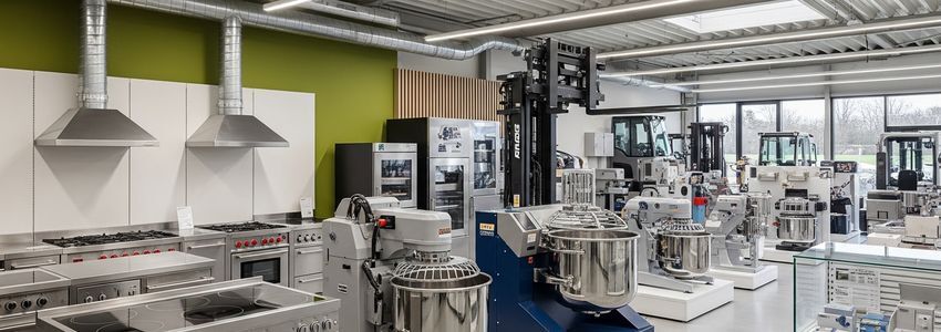 A commercial equipment showroom featuring industrial machinery and kitchen equipment relevant to multi-location business rollouts