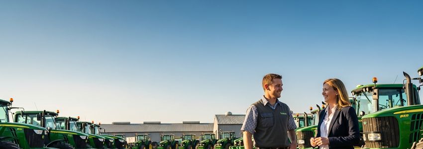 Agricultural business owner reviewing farm loan options with a financial advisor