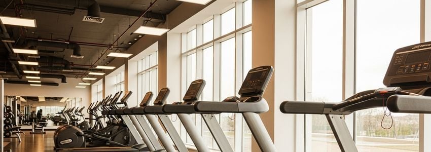 Modern commercial gym interior showing rows of fitness equipment eligible for financing