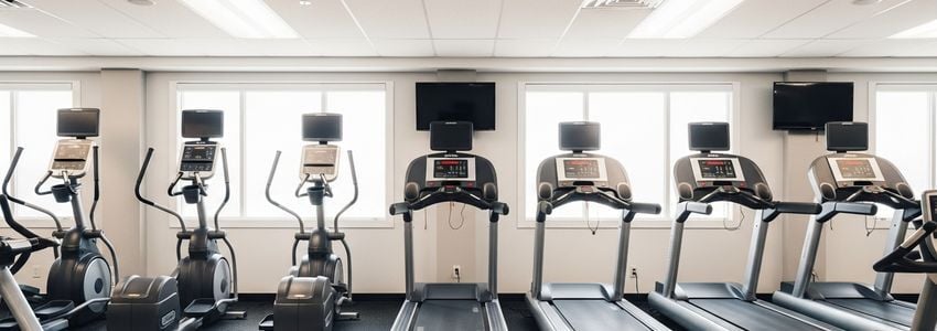 Modern commercial treadmills and cardio equipment in a fitness franchise gym