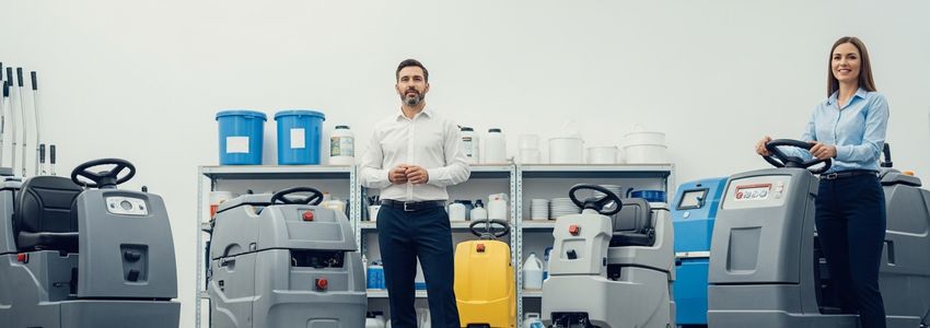 Business owner reviewing commercial floor scrubber equipment financing options in a facility management setting