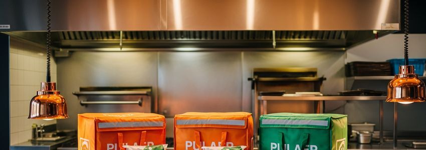 Food delivery business owner reviewing financing options and operations at a professional office desk