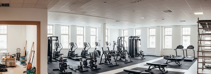Gym renovation in progress with new equipment installed while construction continues